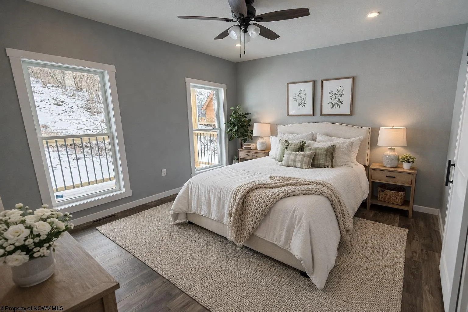 Master bedroom with king bed, ceiling fan and mountain views