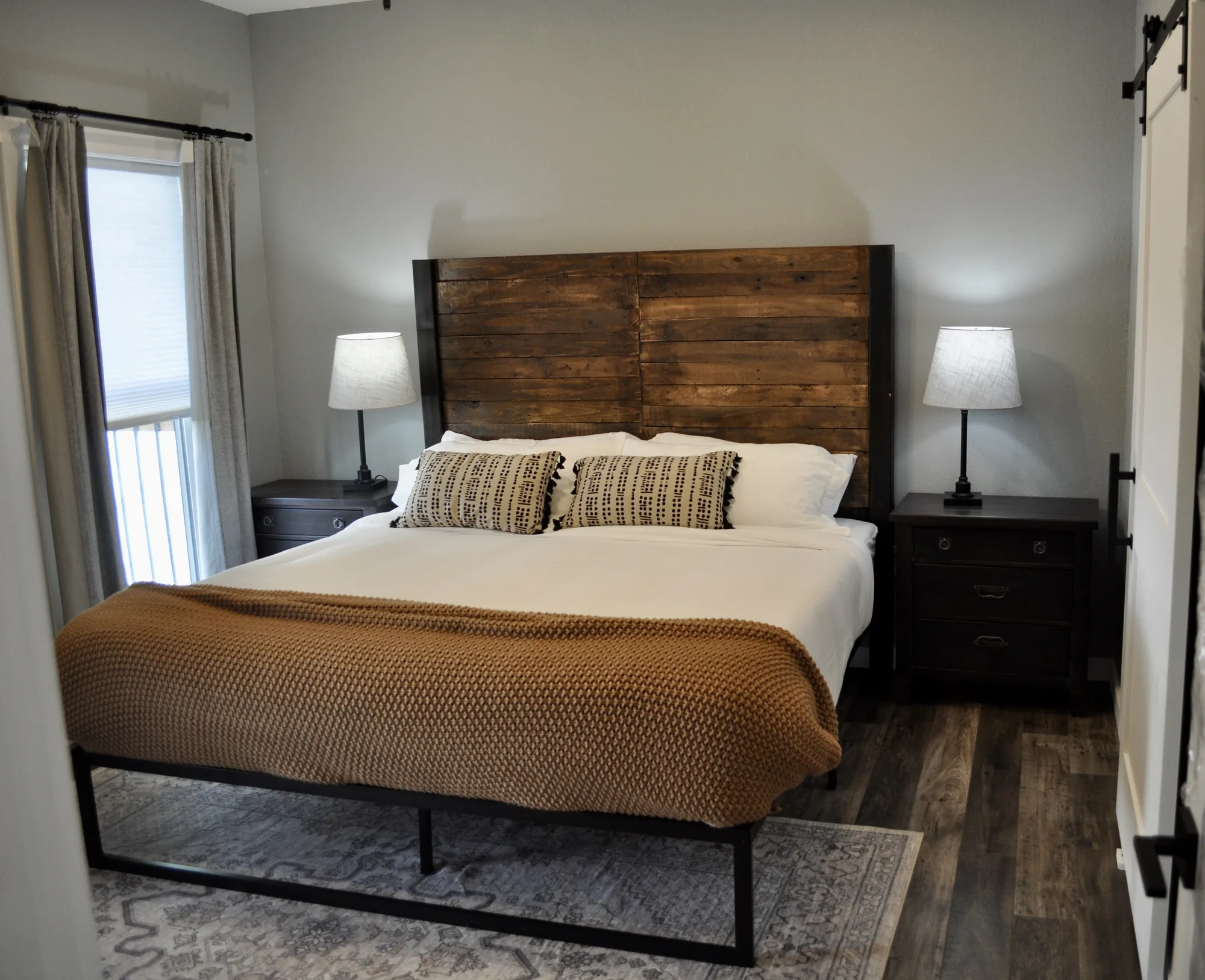 Primary suite with king bed and reclaimed-wood headboard