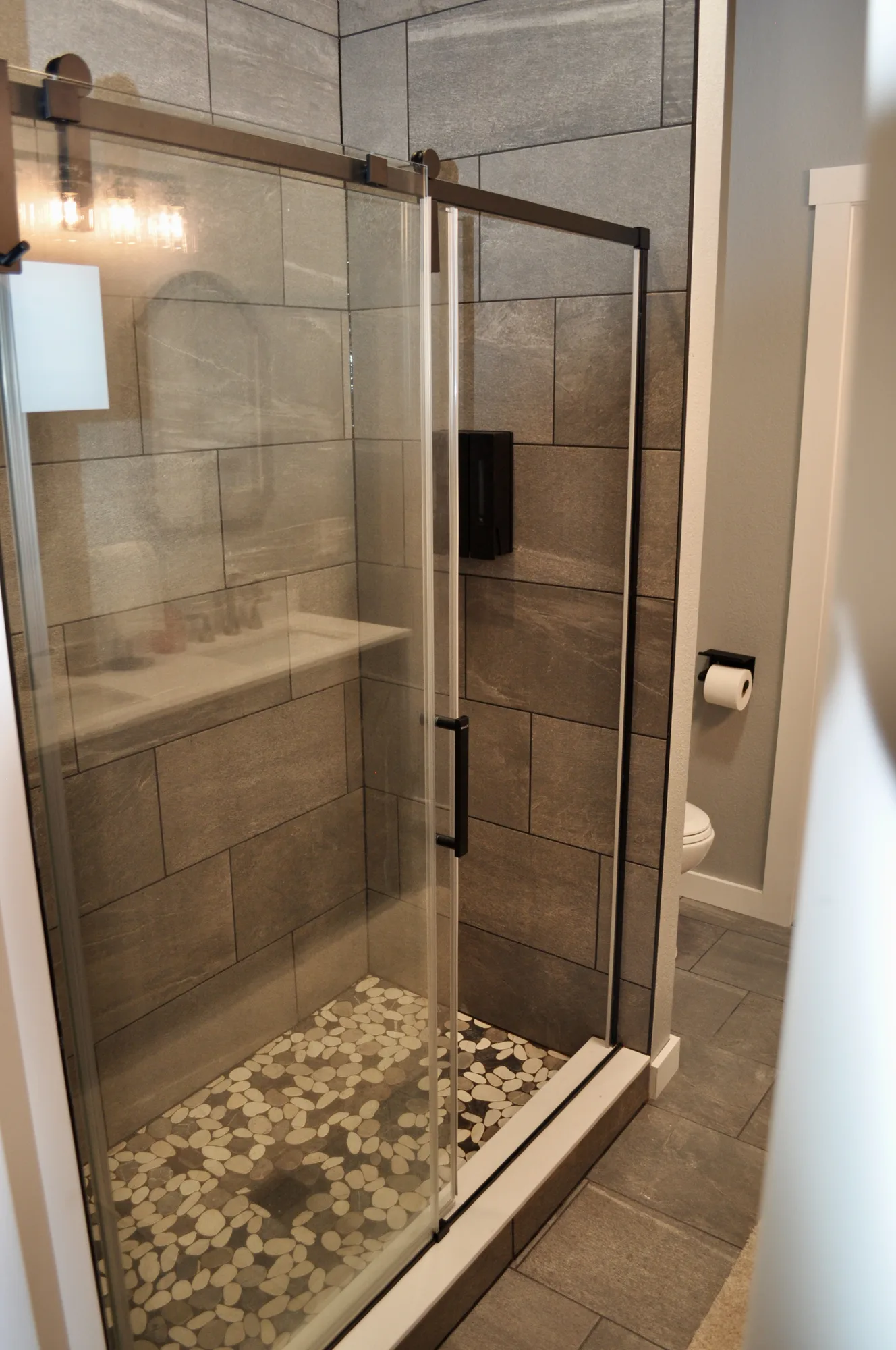Spa-style walk-in shower with pebble-stone floor